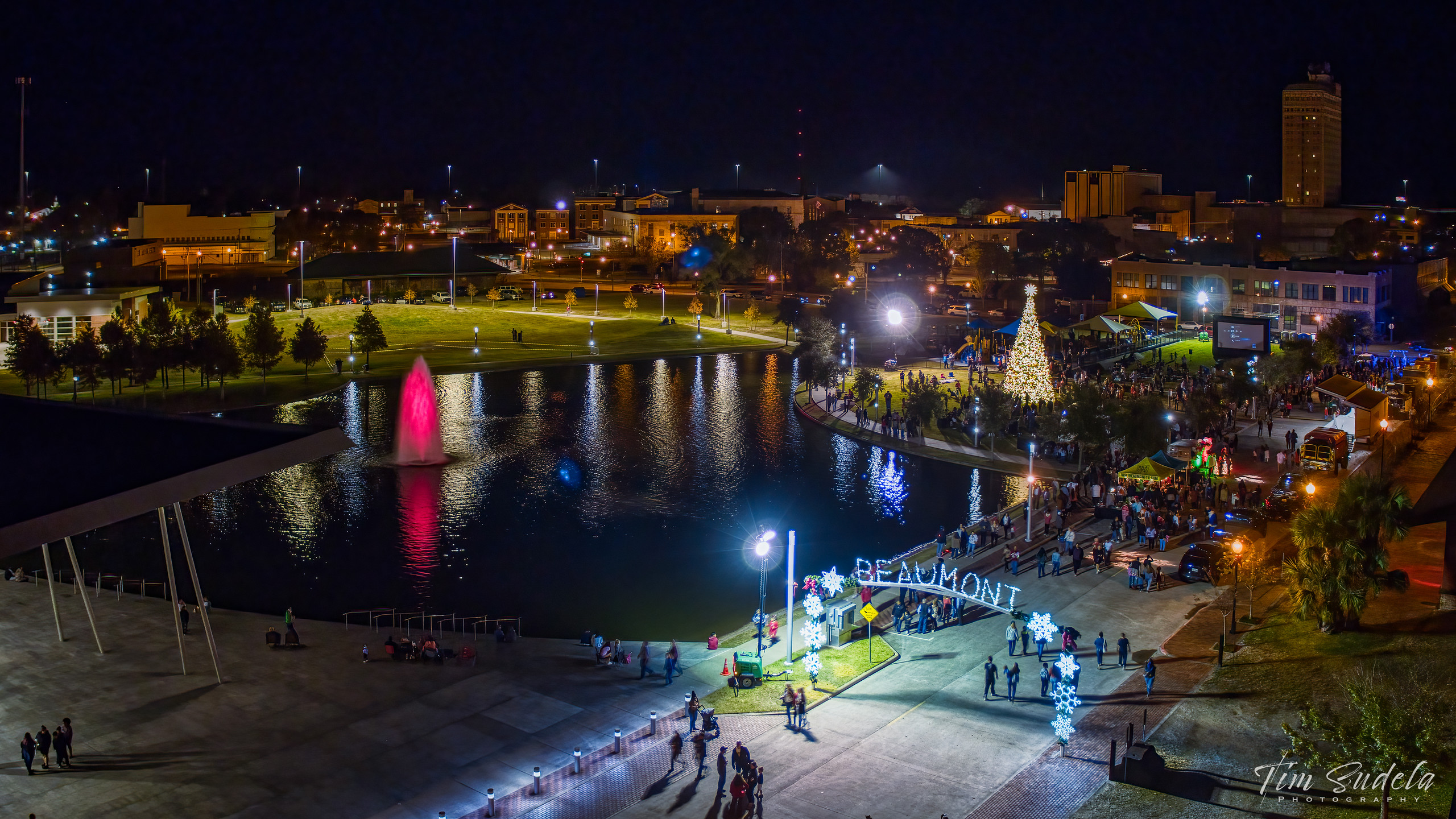 Beaumont Christmas tree lighting event at night with illuminated fountain and crowds.