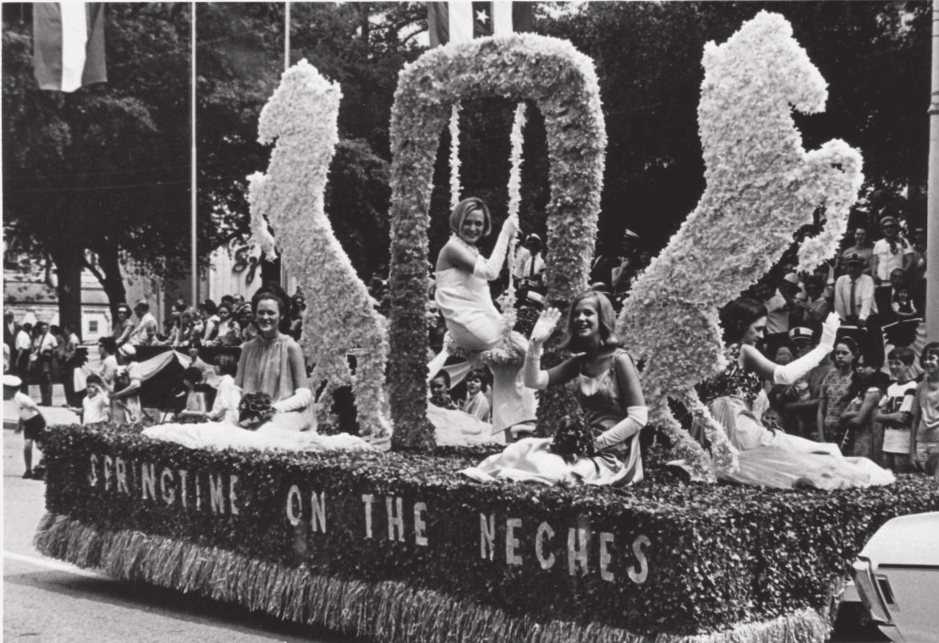 Springtime on the Neches parade float with women in dresses.